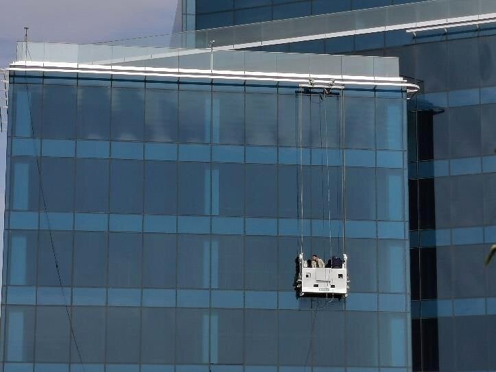 Suspended cradle working on the façade, Baraka Co.