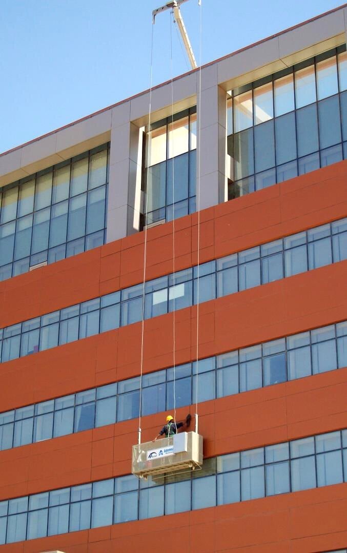 Suspended cradle working on the façade, Dana Gas Egypt